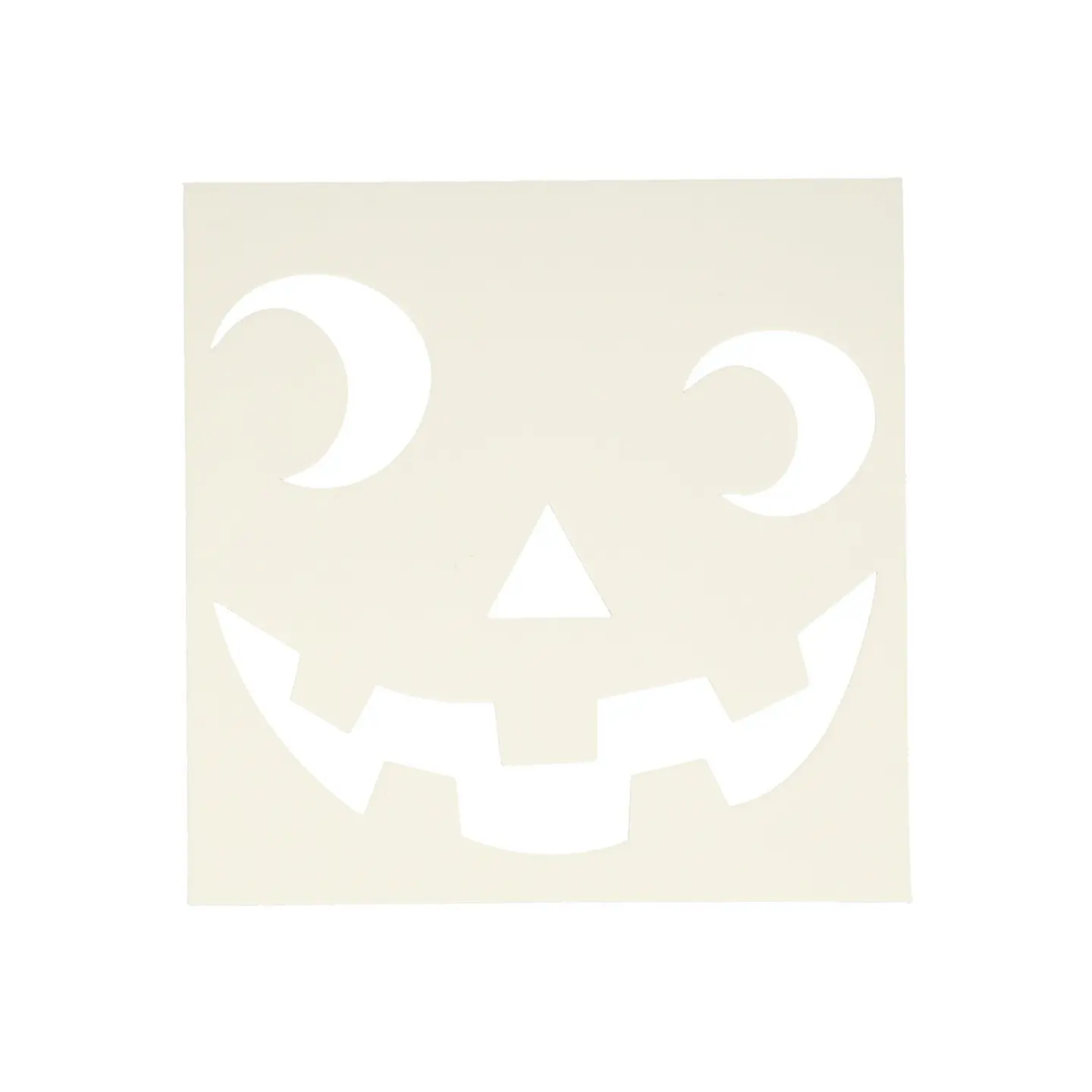 White pumpkin face cutout on a beige background