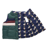 Green quilted vest with a navy blue patterned coverall on a white background
