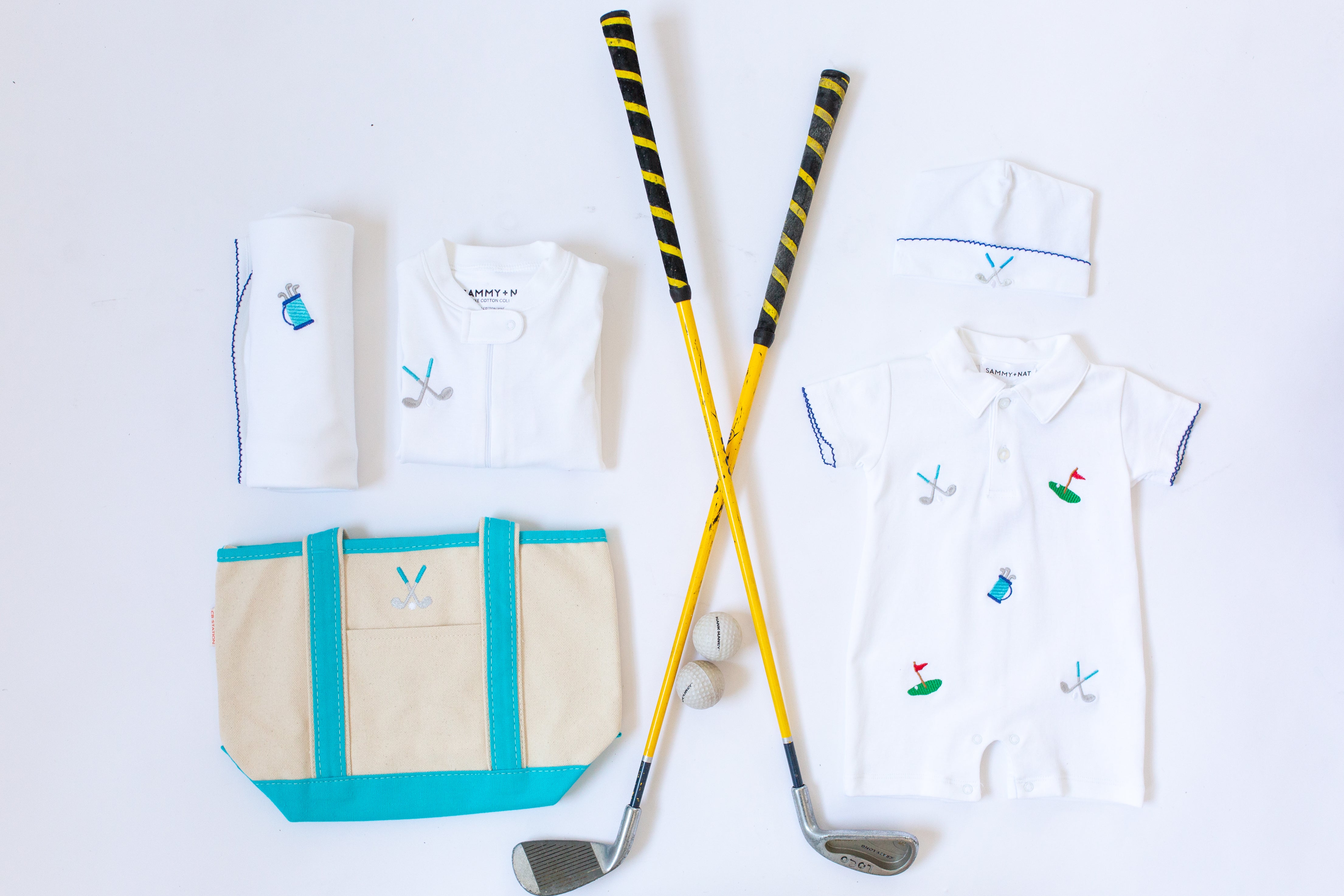 Collection of baby gold gear with golf clubs
