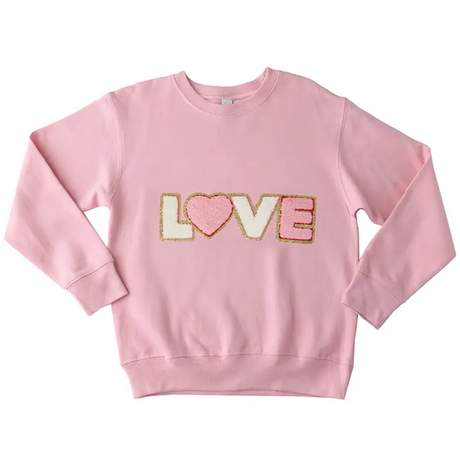 Pink sweatshirt with 'LOVE' in colorful sequins on a white background