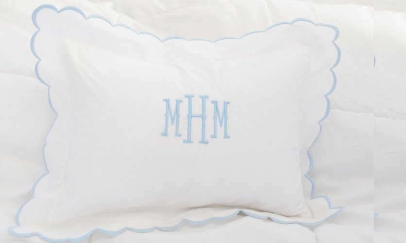 monogram pillow on a bed