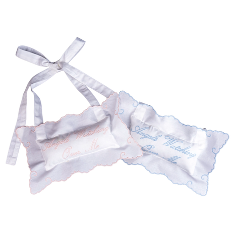 White pillows with bow on white background