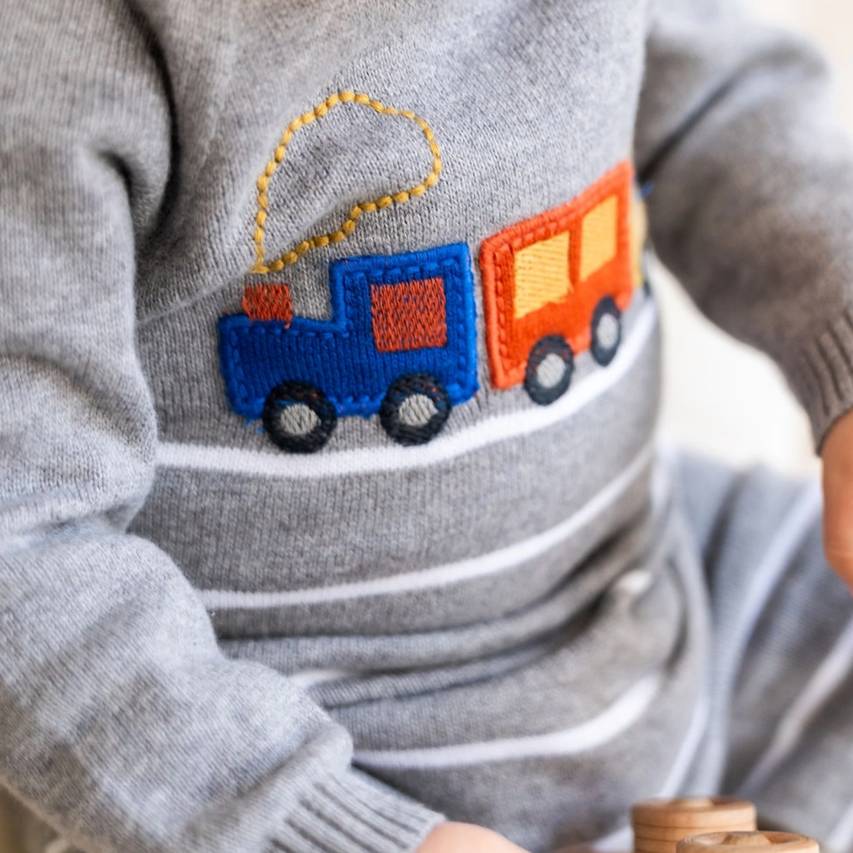 upclose shot of a baby wearing the grey onesie