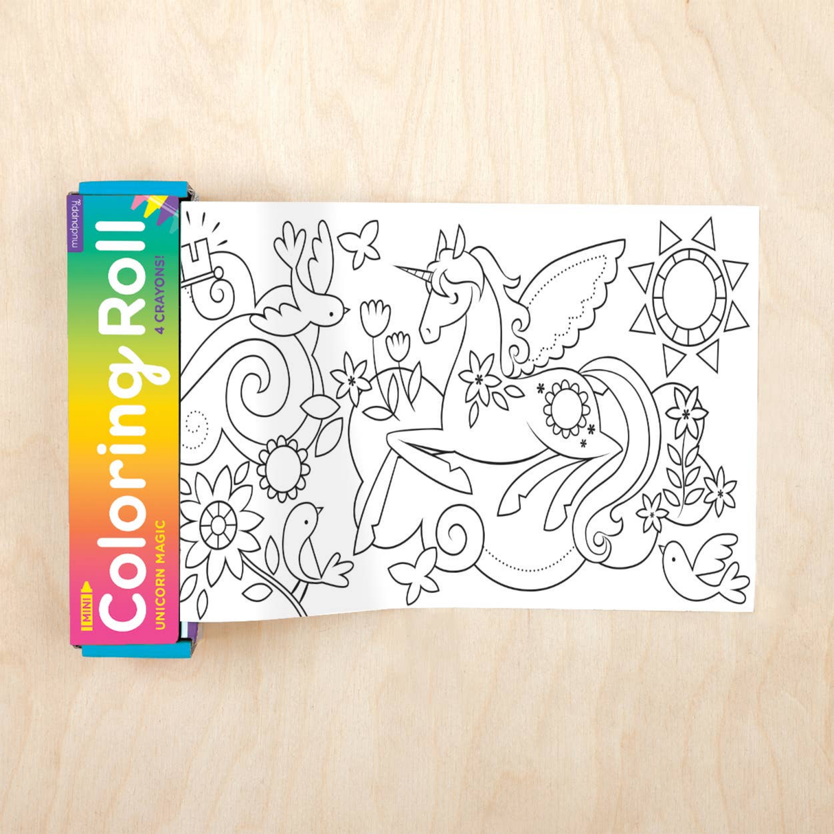 Coloring roll with a unicorn design on a wooden surface