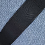 Close-up of a black strap on a textured blue fabric background