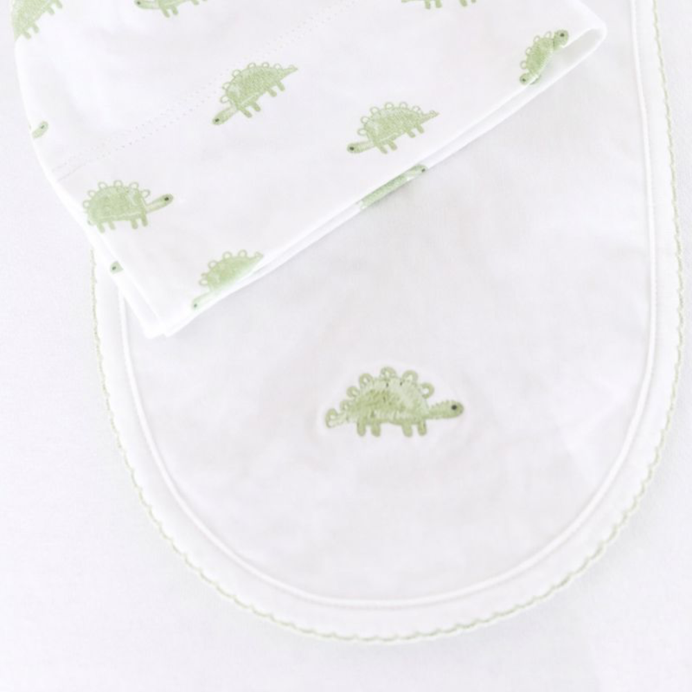White bib with green dinosaur patterns on a white background