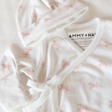 Baby outfit with pink animal pattern on a white background