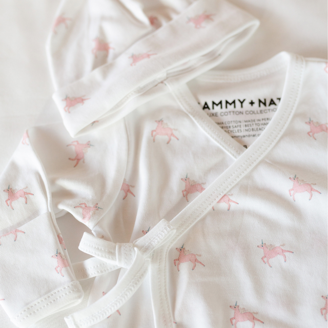 Baby outfit with pink animal pattern on a white background