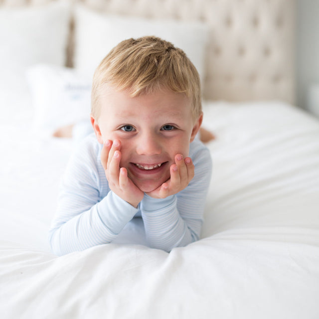 boy wearing blue stripe pajamas