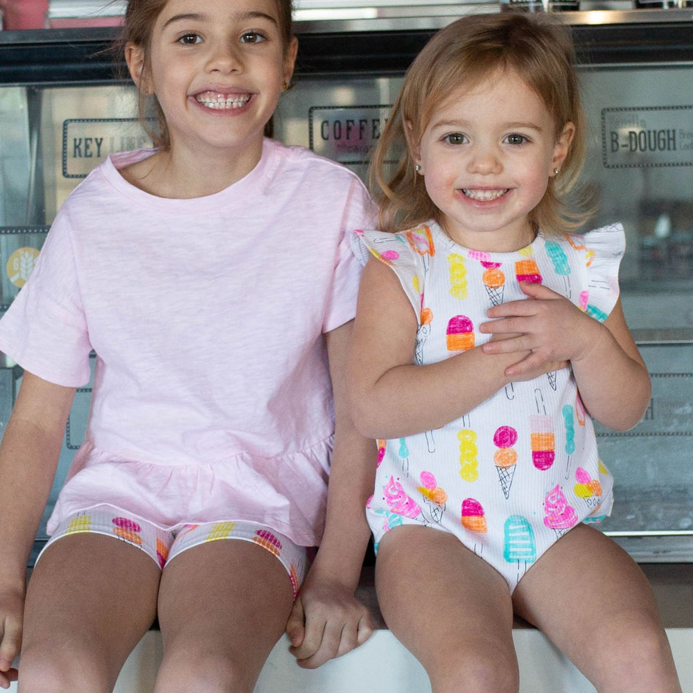 girls sitting wearing ice cream print clothing