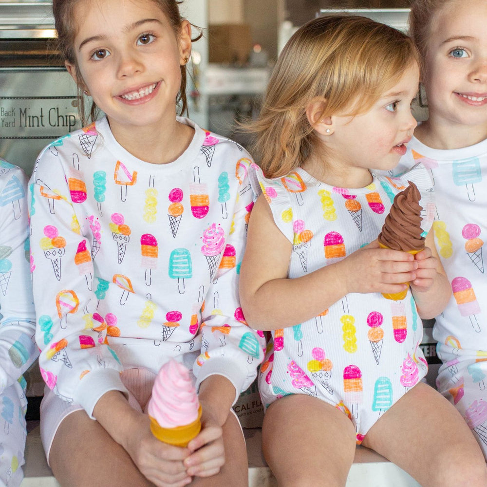 girls sitting with ice cream onesie and ice cream sweatshirt