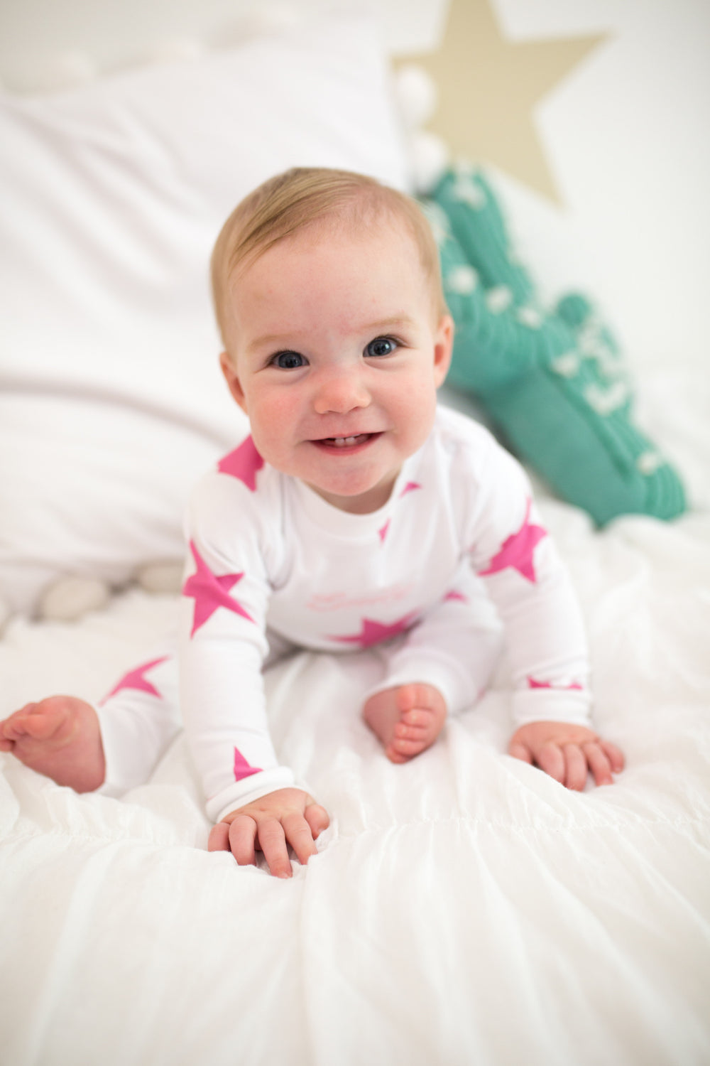 baby wearing pink star pajamas