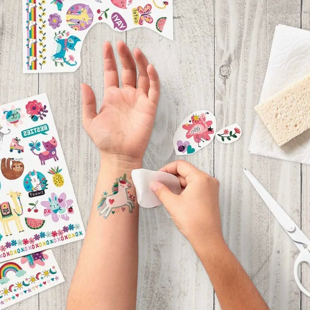 girl putting on tattoos