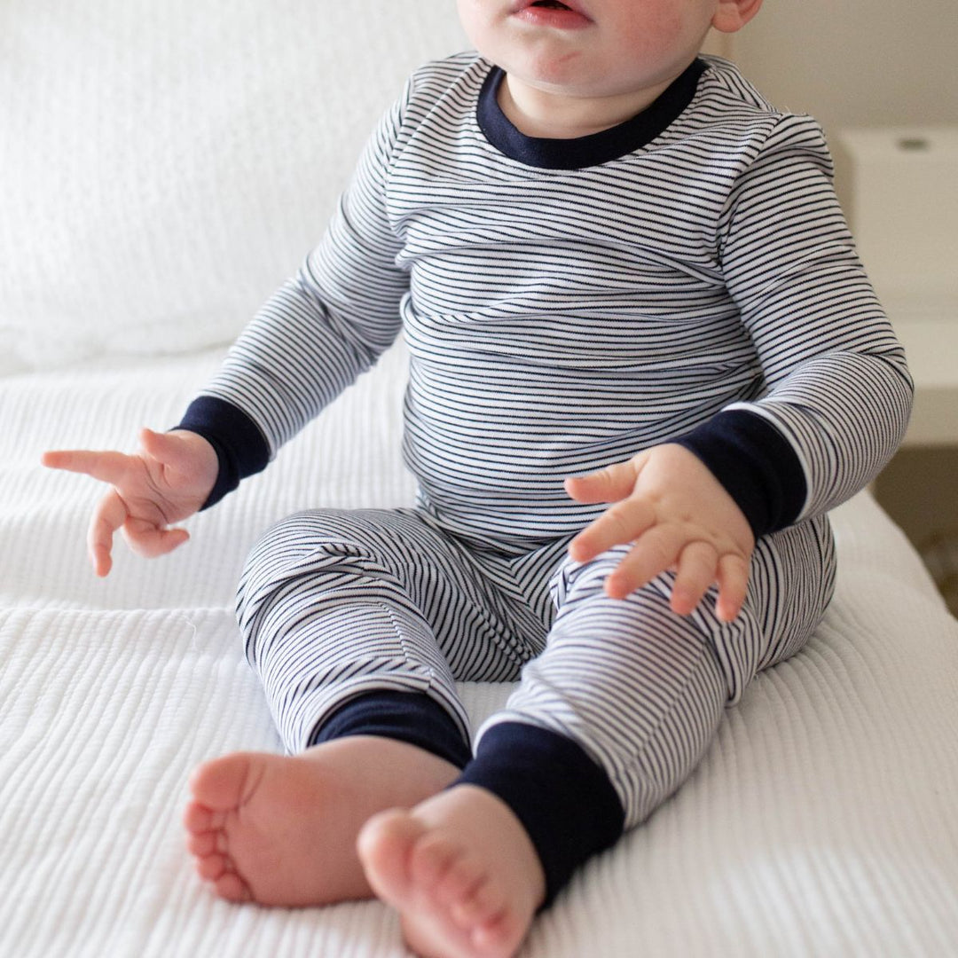 baby wearing navy striped pajamas